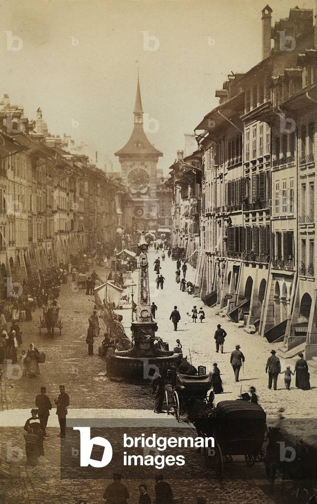 A central street of Bern, Switzerland. The clock in the background, the symbol of the town clock tower