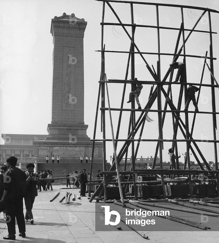 View of Tiananmen Square in Beijing with people and workers on scaffolding (b/w photo)