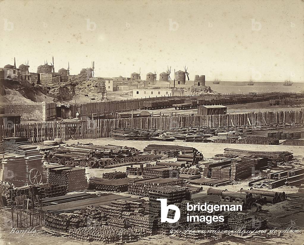 Yard for construction materials, windmills are in the background, in Alexandria, Egypt
