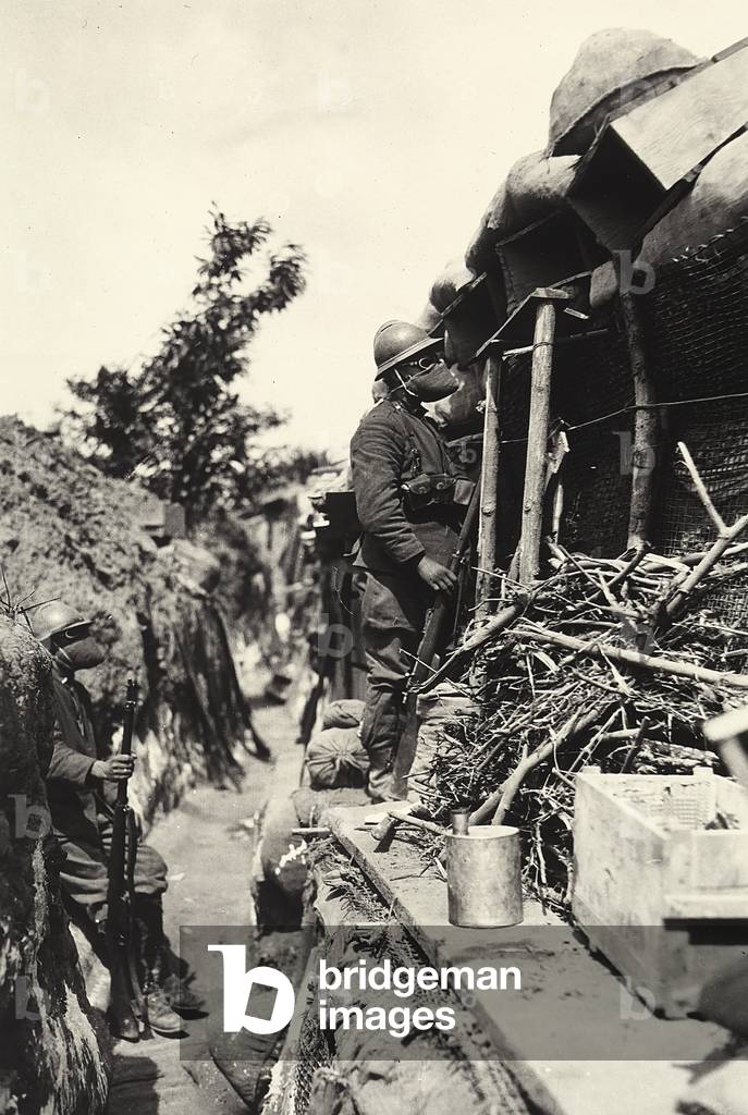 Italian soldiers in trenches, wearing gas masks, during World War I (b/w photo)