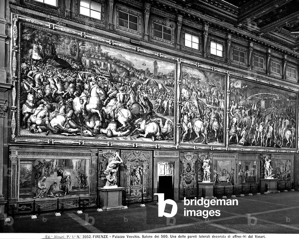 Side wall decorated with fresco paintings in Salone dei Cinquecento in Palazzo Vecchio in Florence.