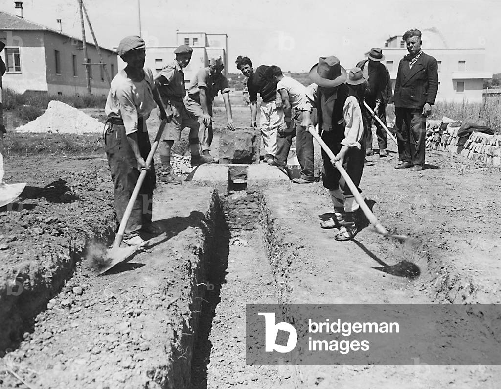 Digging latrine trenches in the camp at Cesano, near Rome, which was found in an unsanitary condition (b/w photo)