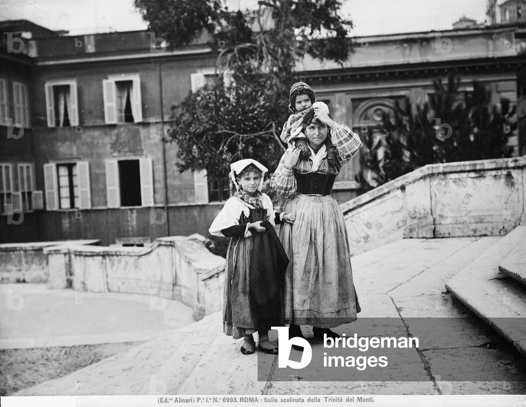A woman and her daughters on the staircase of Trinità dei Monti in Rome