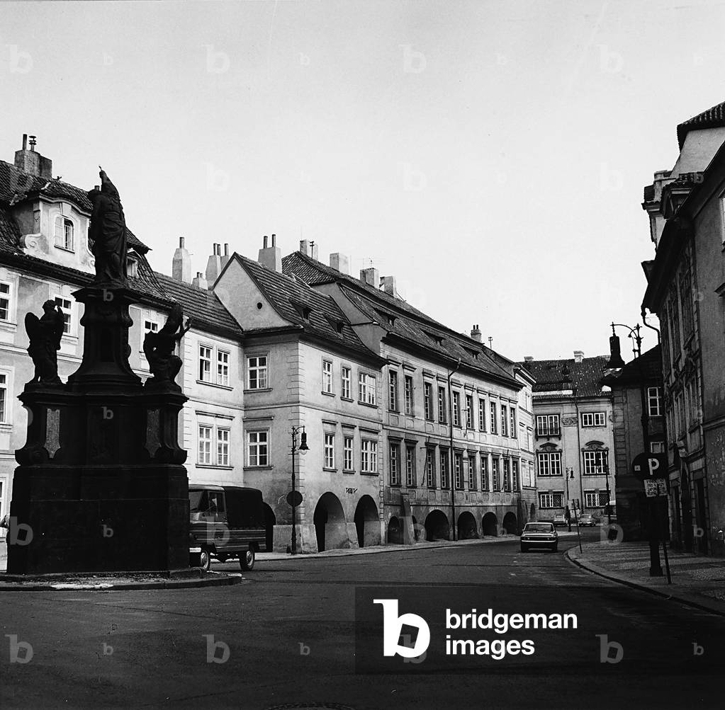 A street in the Malà Strana quarter in Prague. A commemorative monument is in the left foreground