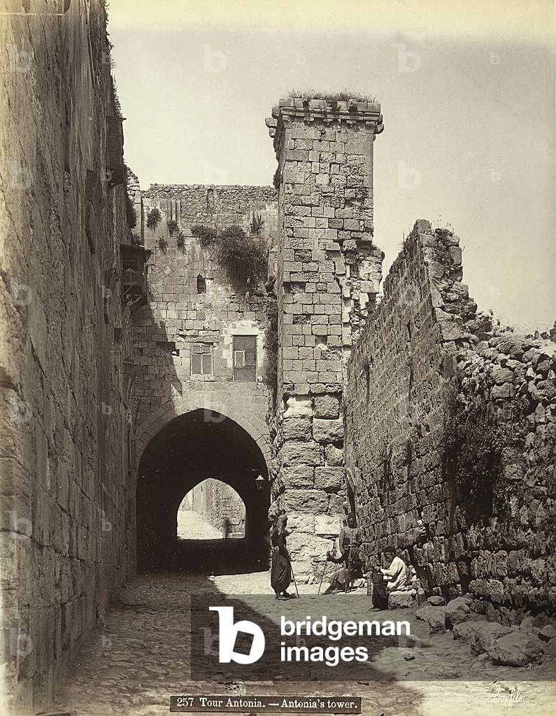 The Antonia Tower in Jerusalem. Some men are resting near the walls