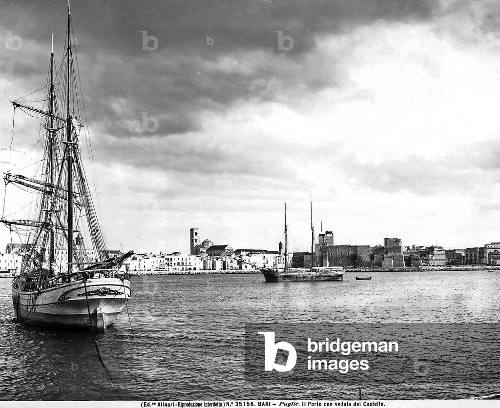 View of the Port of Bari with two sailboats. The Castle is in the background. 