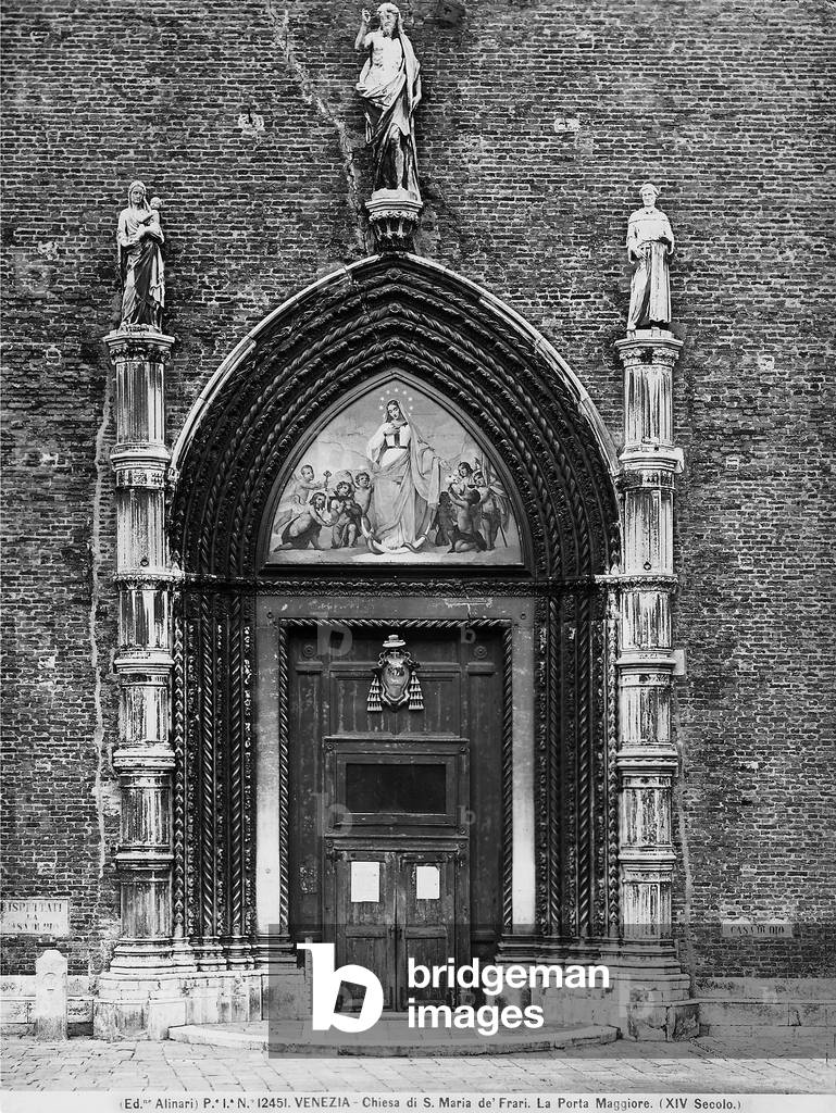 The doorway of the church of Santa Maria Gloriosa dei Frari in Venice. A statue of the risen Christ, by Alessandro Vittoria, is at the cusp, and statues of the Madonna and Child and St. Francis, from the School of Bartolomeo and Giovanni Bon, are on the pinnacles on each side of the doorway