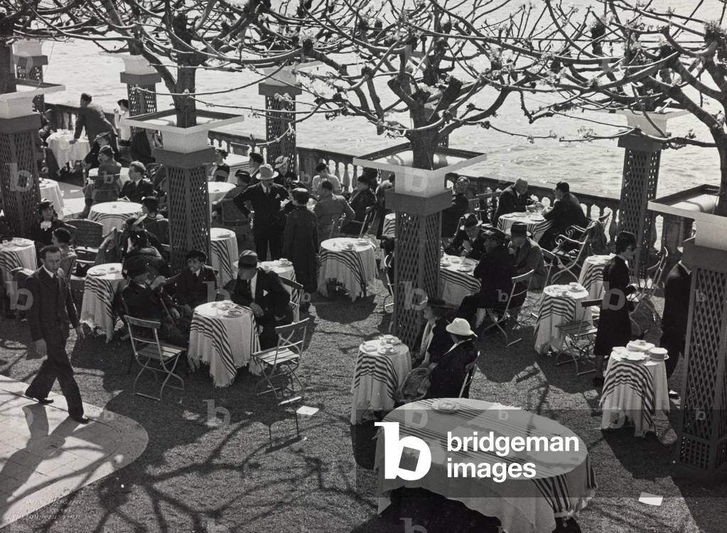 Group of people sitting at the café during a fashion event