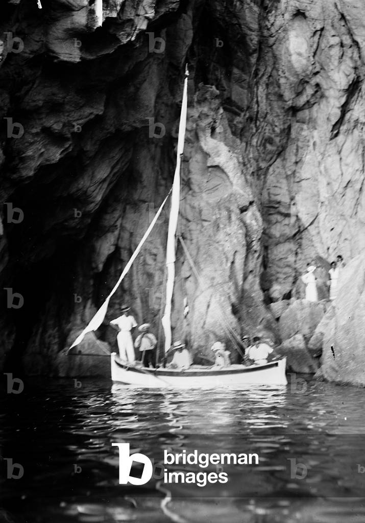 Group of tourists on board a boat in a cave on the Island of Elba