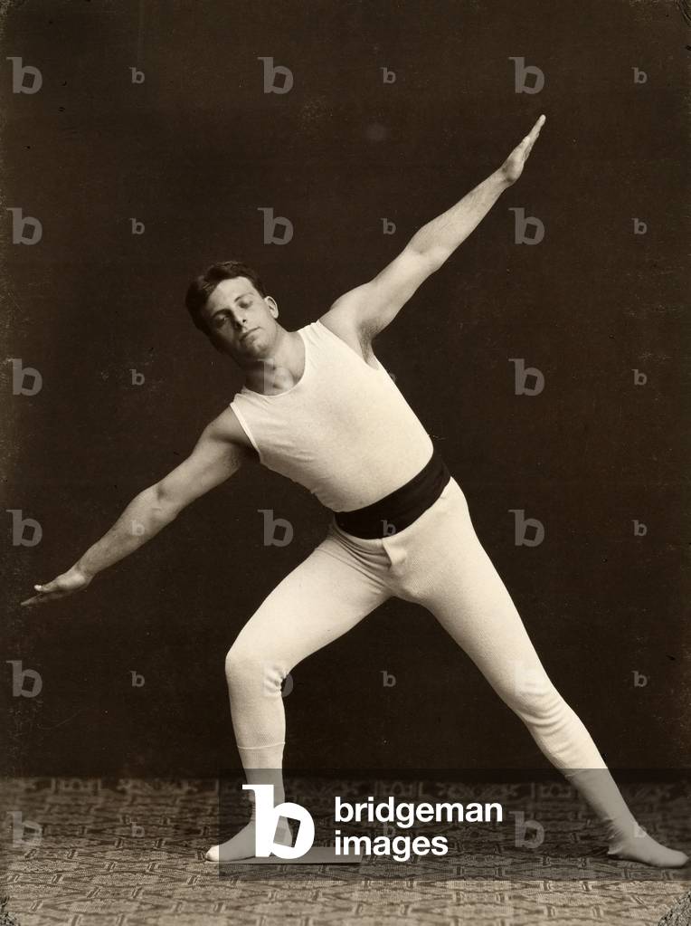 Portrait of a gymnast as he performs an exercise
