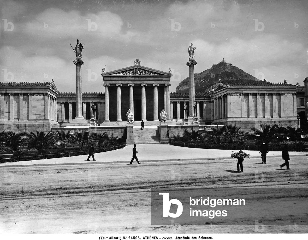 View of Athens with the Academy of Sciences in the foreground, a building in the shape of a temple with ionic columns in the pediment.
