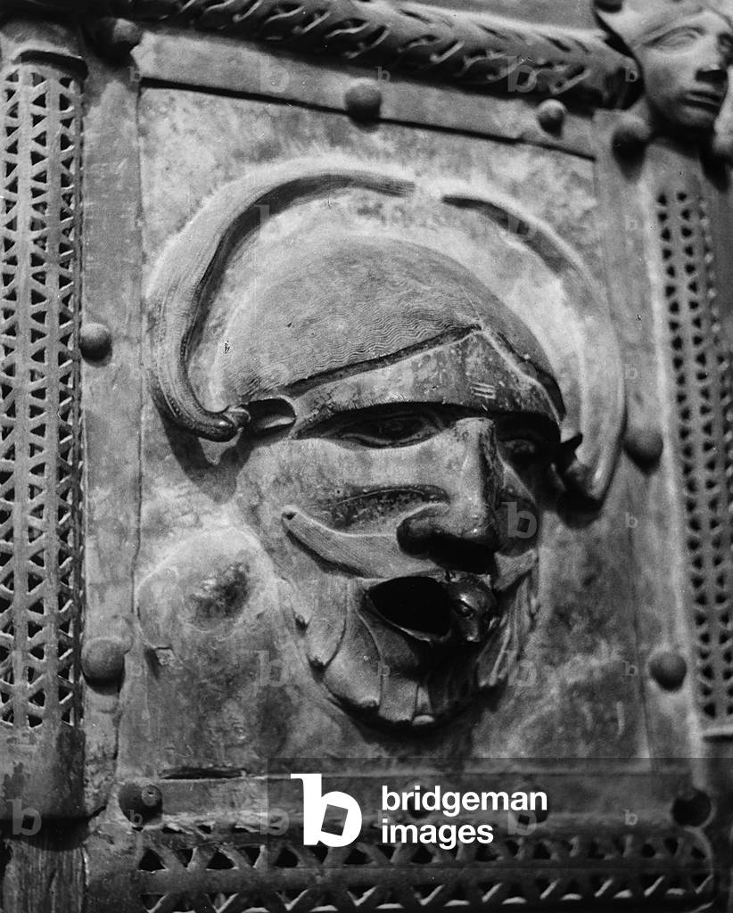 Panel from the Bronze Doors of St. Zeno in Verona, showing a grotesque mask
