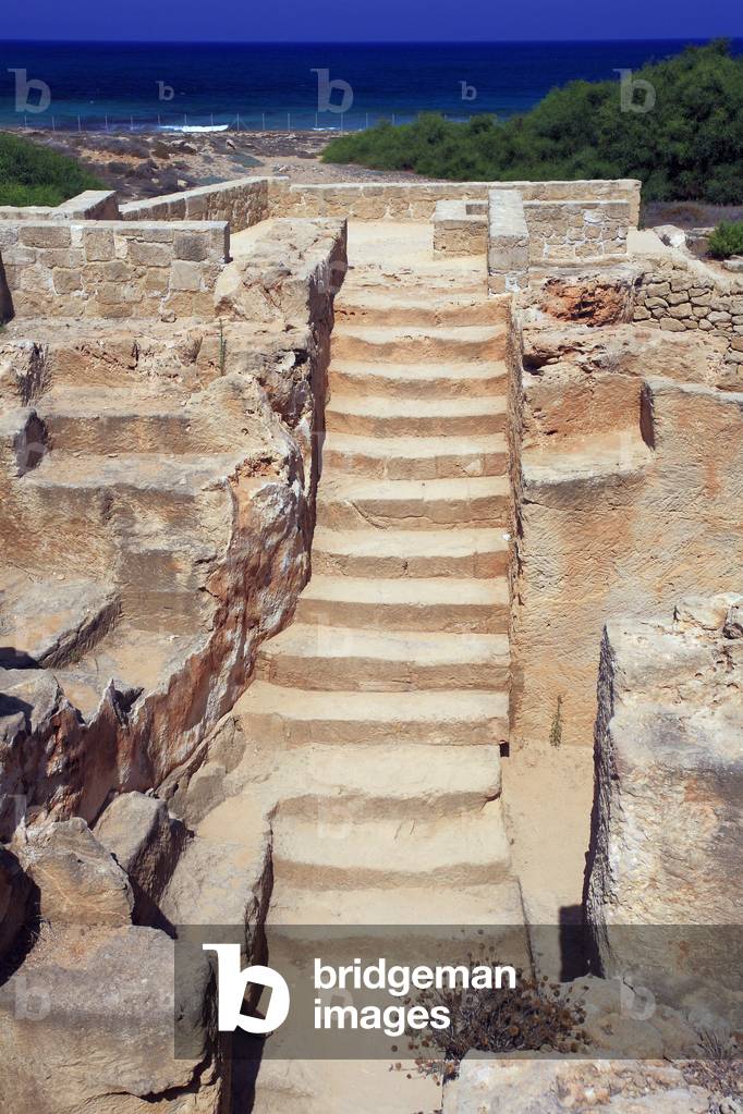 Tombs of the kings, View upon the stairs leading to a funeral chamber and loculi, Early Ptolemaic necropolis in a Hellenistic Doric style, dating from 300 BC, The necropolis was continuously used as a burial area during the Hellenistic and Roman periods (3rd century BC-beginning of 4th century AD) Paphos, Cyprus - View on the entrance of a tomb leading to a funerary chamber of the Necropolis known as the “Tombs of the Kings”, Necropole Ptolemaic Hellenistic-Doric style, Place that served as a cemetery during the Hellenistic and Roman periods and place of refuge for the first Christian during the persecutions, UNESCO site, 3rd century BC - 3rd century AD, Paphos, Cyprus,