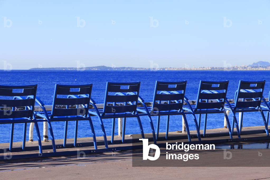 Blue chair, urban furniture on 'La promenades des anglais' in Nice in front of the sea. French Riviera (Alpes-Maritimes), France.