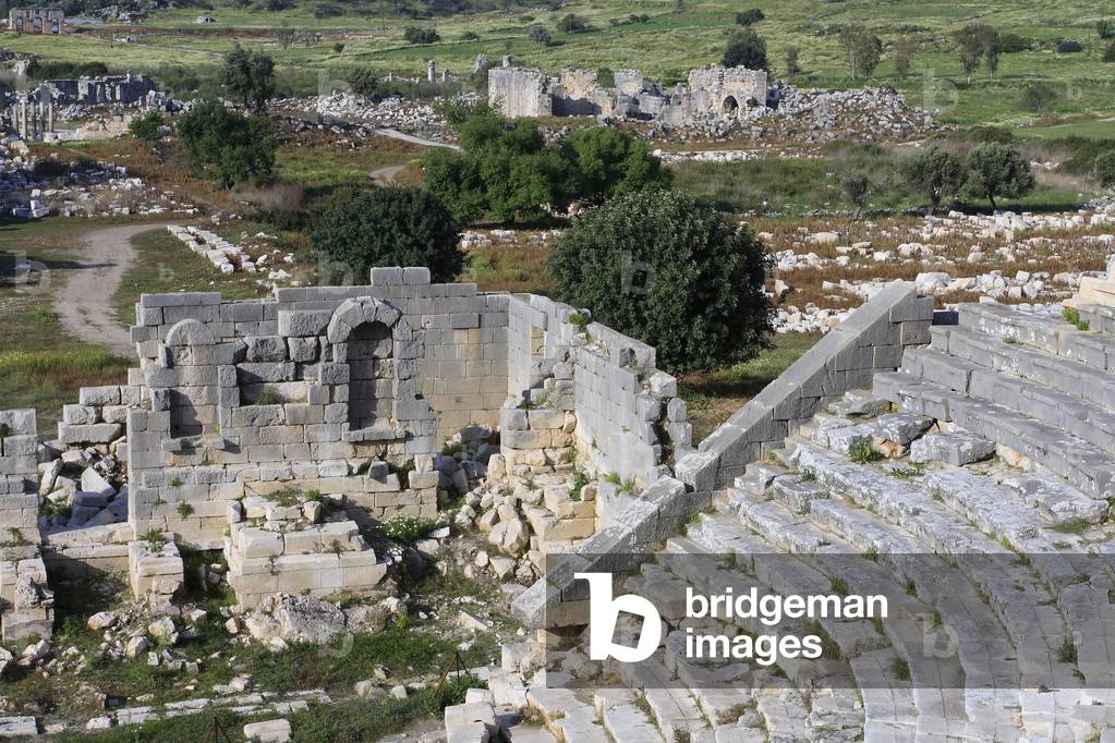 General view of the Patara site from the stands of the theatre, stage wall in the foreground, then the Bouleuterion, the main avenue, the thermal baths, and the gates to the site./Patara/Turkey