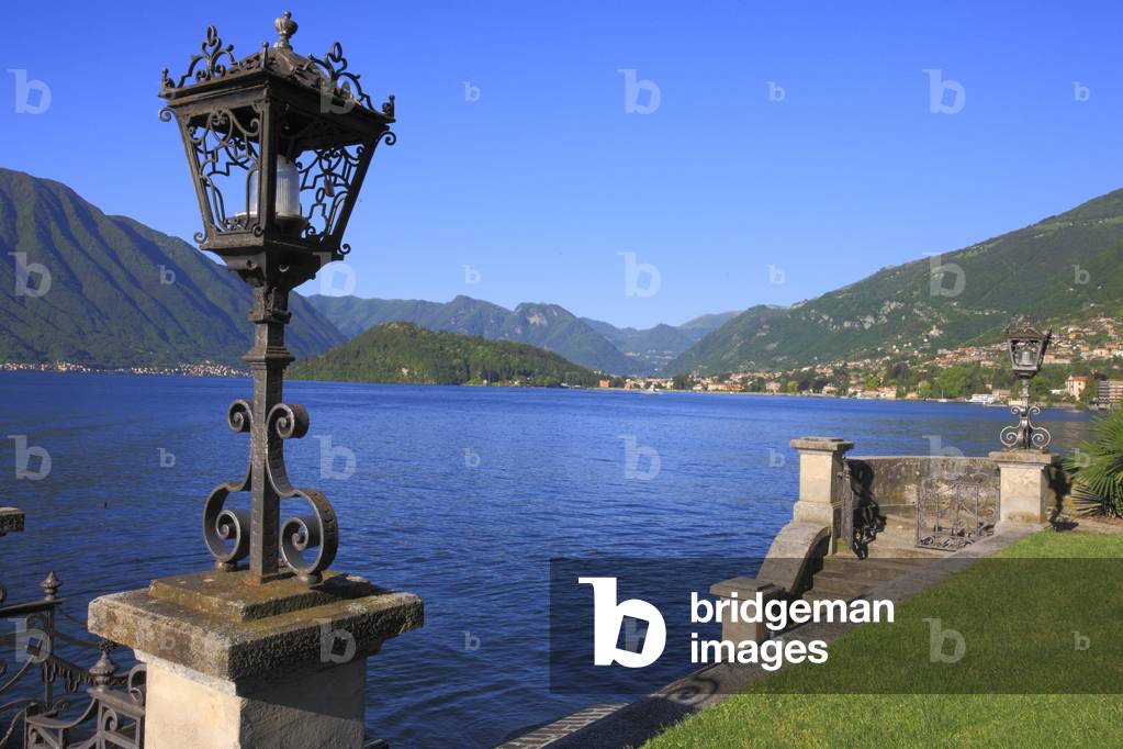 Park, lakeside garden, lawn, pier, access batea, promenade, landscape. Lake Come, Lombardy, Italy.
