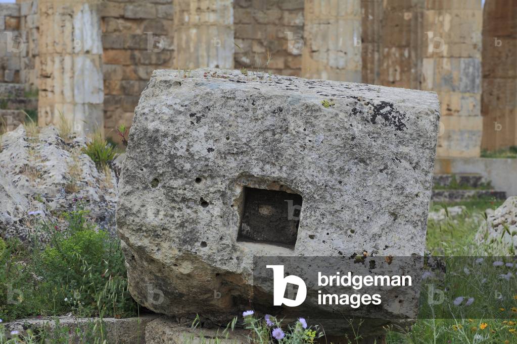 Selinunte: Block of limestone from a colomn with a square hole at the center used for the system of lifting, transportation, or the technique of installation, The “” F”” temple or the temple of Athena or Dionysus, Doric temple architecture, 5th century BC Sicily - Selinonte: block of stone or column with a hole of square shape used for the technique of lifting, transportation, or installation, Temple F or Temple of Athena or Dionysus, Doric Architecture, 5th century BC Sicily