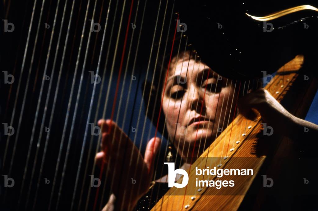 Robles, Marisa - playing harp Spanish Harpist, 1937- Face seen through strings