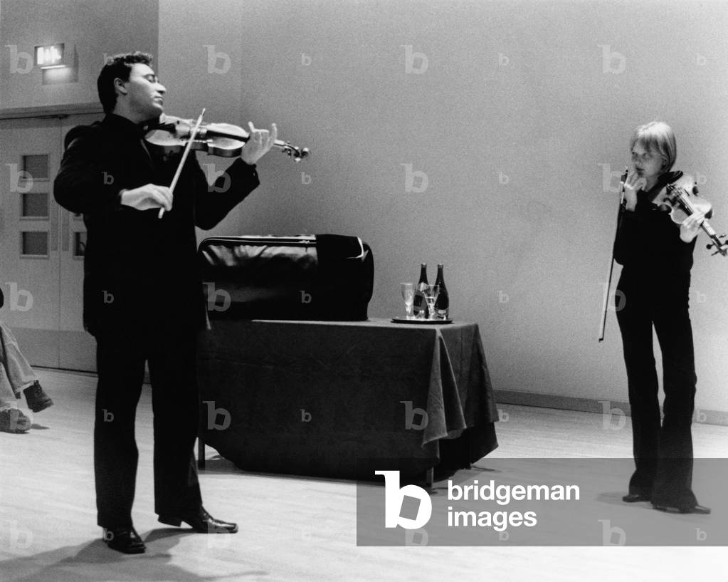Maxim Vengerov demonstrates a point of interpretation to violinist Alina Ibragimova, a participant in his violin  masterclass at St Paul's School, London, 28 January 2002