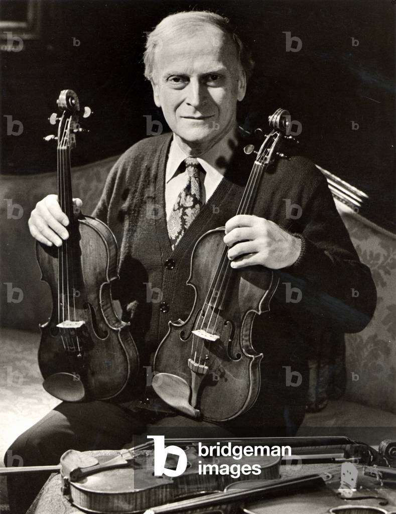 Yehudi Menuhin holding two of his Stradivarius violins, 1970