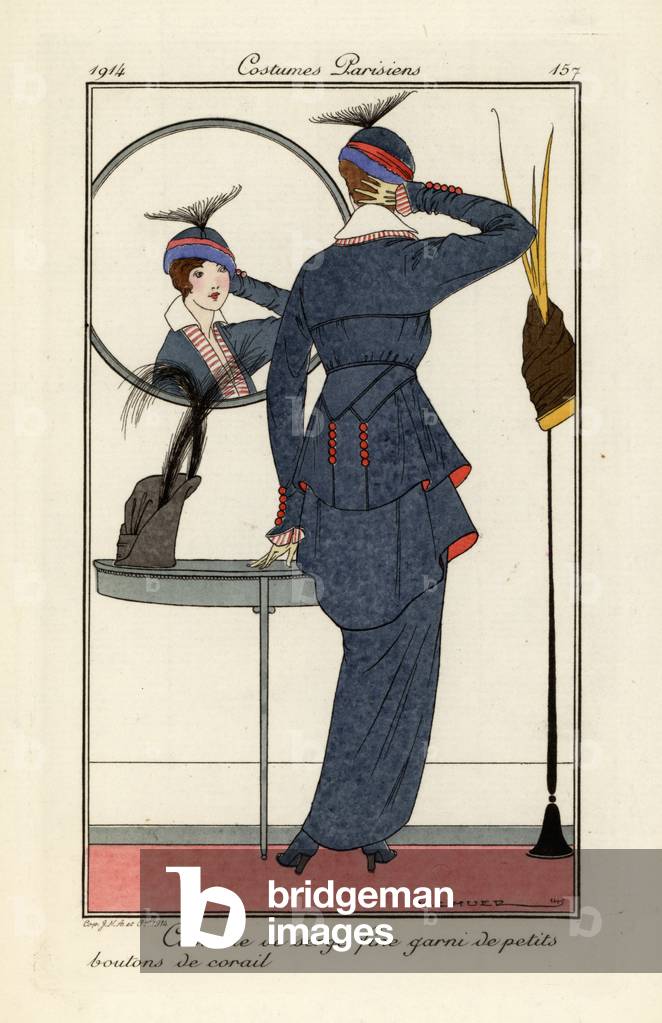 Woman in fine serge suit with coral buttons looking.