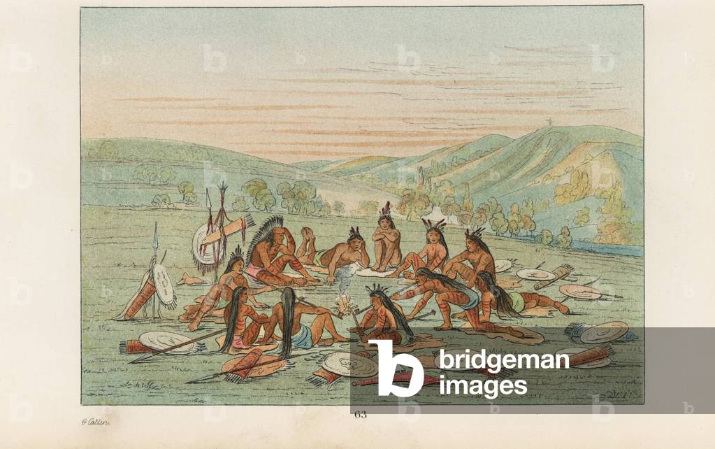 Mandan war party resting on buffalo hides and smoking tobacco pipes around a fire. Handcoloured lithograph from George Catlin's Manners, Customs and Condition of the North American Indians, London, 1841.