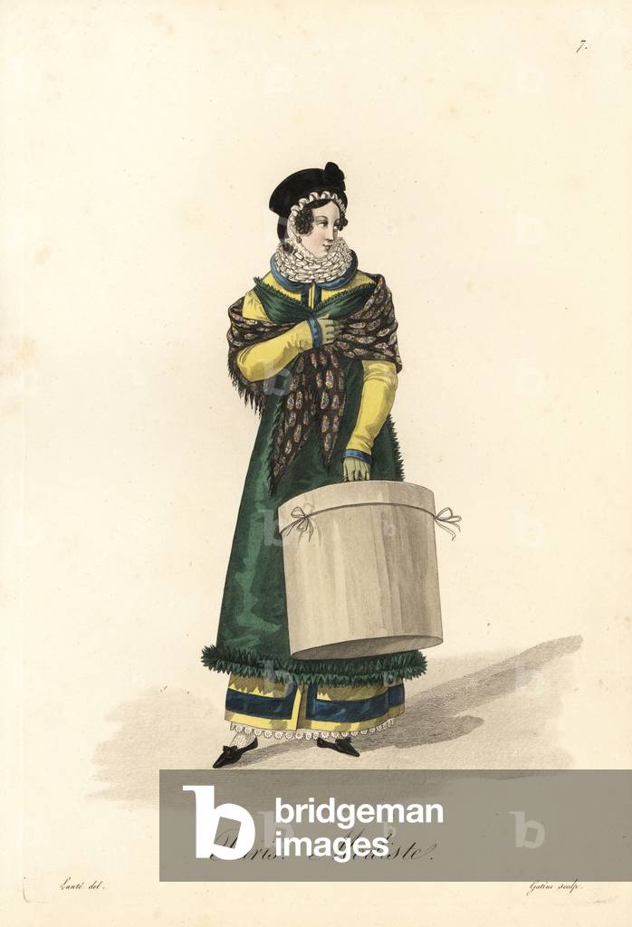 Modiste - Milliner, Paris, early 19th century, in bonnet, lace collar, shawl, green apron over yellow dress, carrying a hat box - Handcoloured copperplate engraving by Gatine after an illustration by Louis-Marie Lante from “” Ouvrieres de Paris” (Tradeswomen of Paris), Paris, 1823