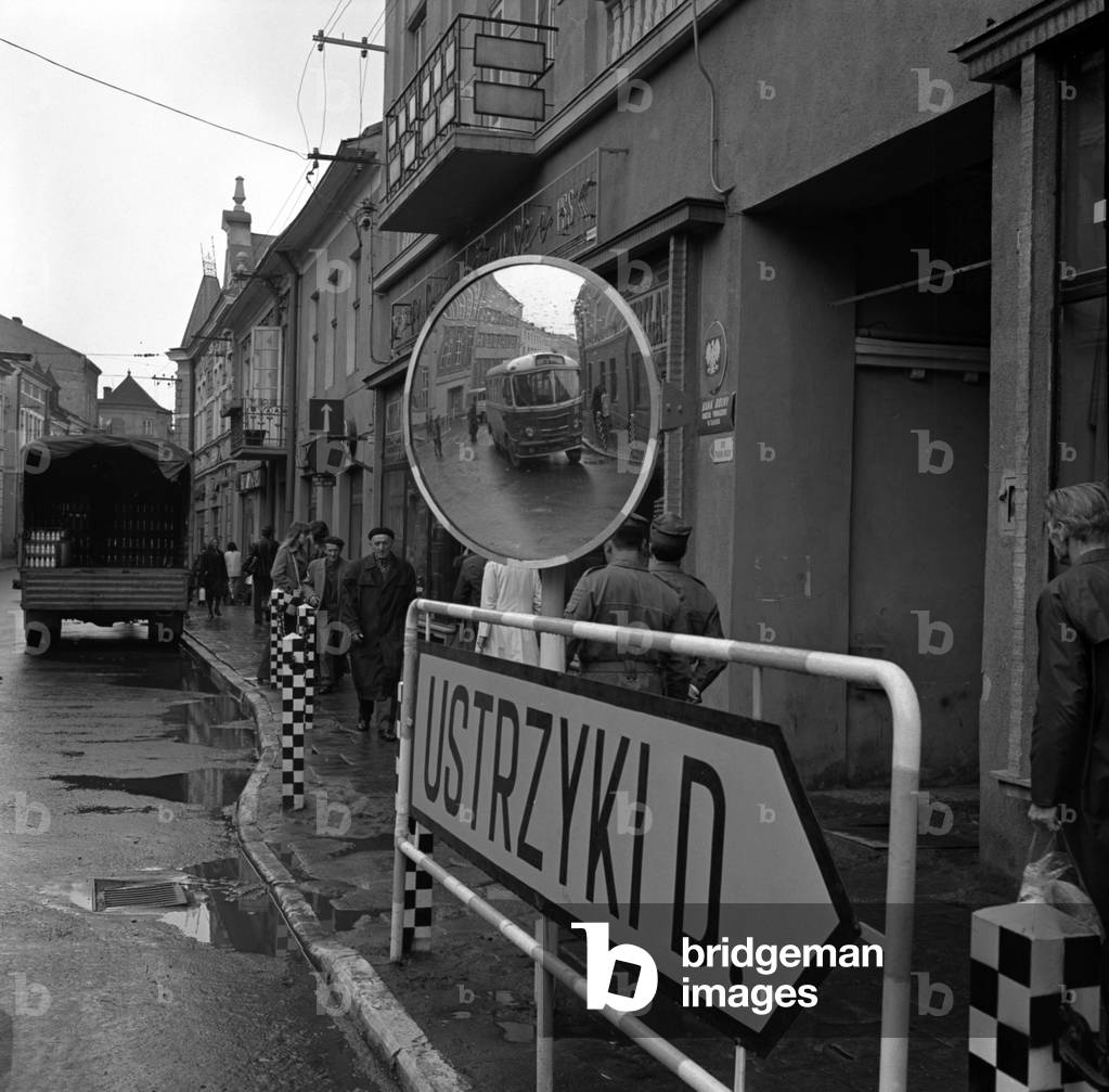 Sanok, Poland, 03.05.1974. Street with signpost and road mirror in town in Bieszczady. 