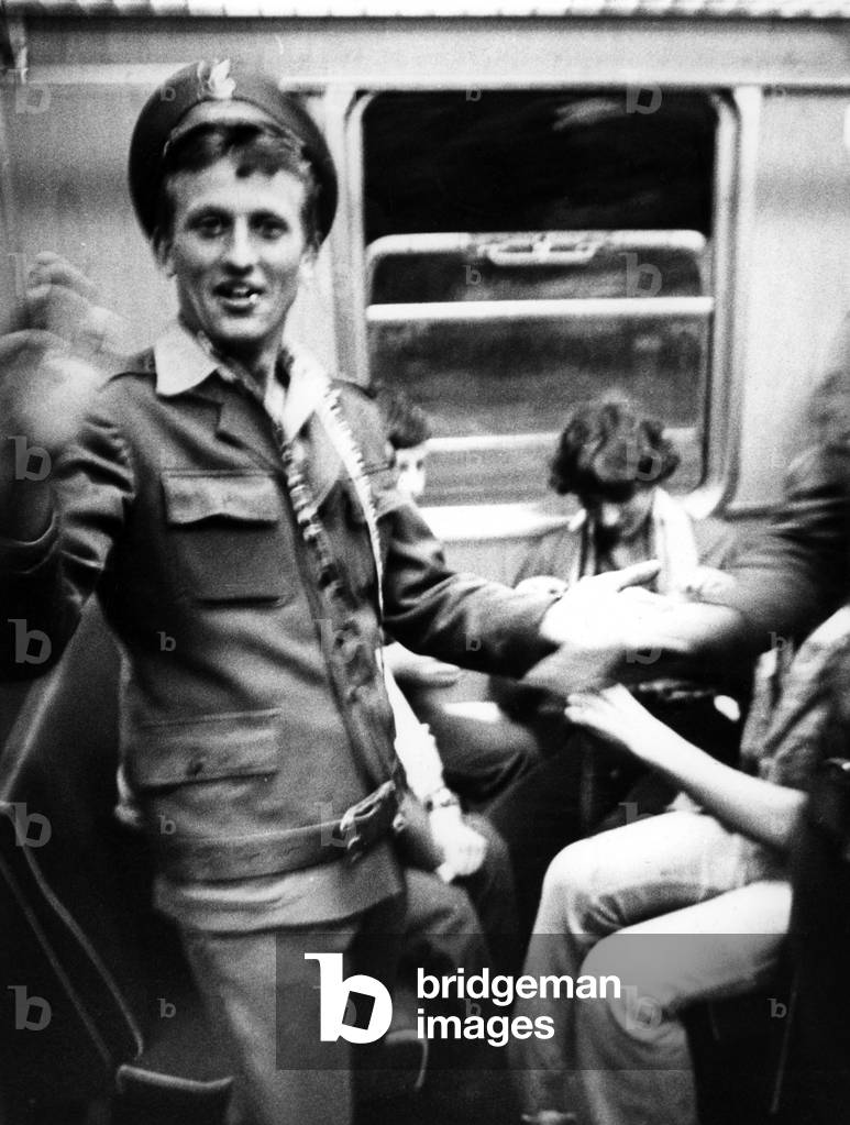 Warsaw, Poland, 1978. Joyful soldier in a train compartment. 