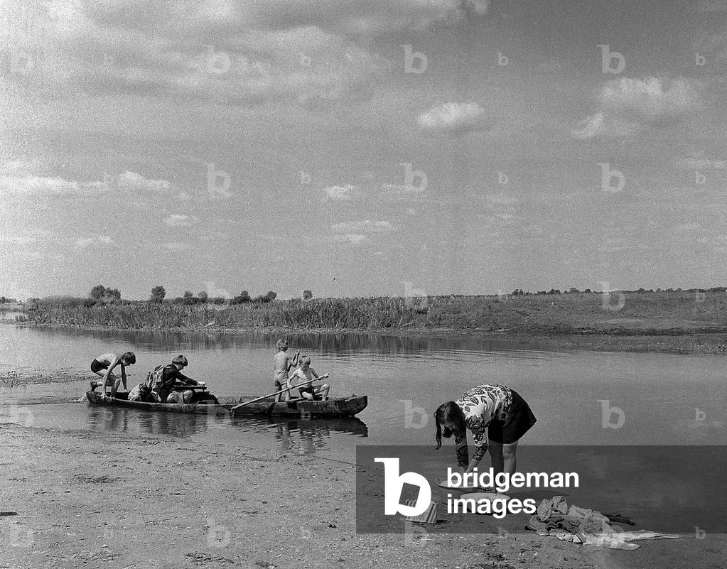 Zlotoria, Podlaskie province, Poland, 07.1976. Actress Ewa Benesz washing her clothes in the river. Ewa Benesz made a countrywide tour to declaim Adam Mickiewiczs epic poem 'Pan Tadeusz' ('Sir Thaddeus, or the Last Lithuanian Foray') in small villages. 