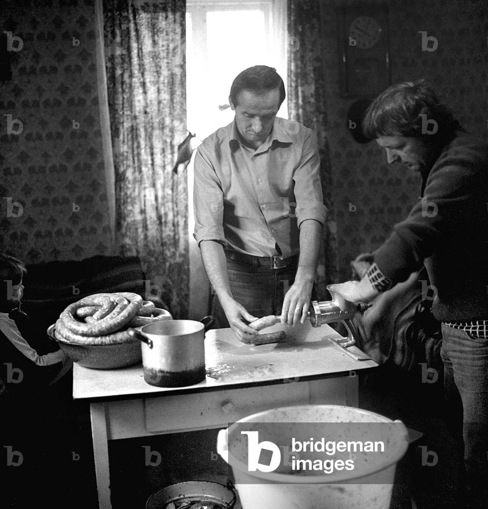 Lublin Voivodeship, Wola Osowinska near Kock, Poland, 1971. People making homemade sausage. 