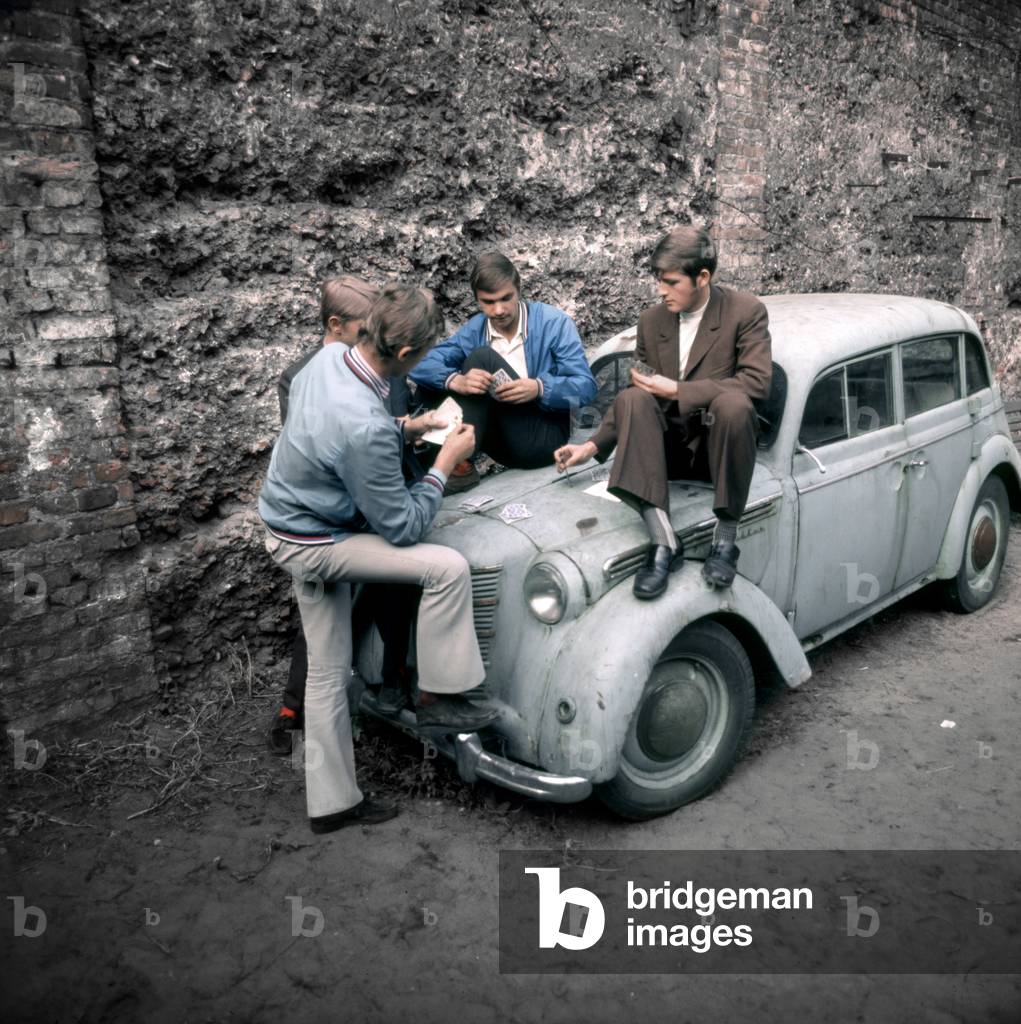 Warsaw, Poland, 1972. Praga disrict. Men playing cards on hood of a car. 