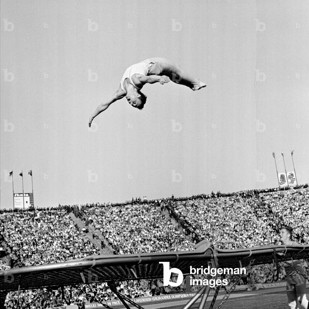 Warsaw, 1966. 10th Anniversary Stadium. End of Peace Race, gymnasts put on show by jumping on trampoline. 