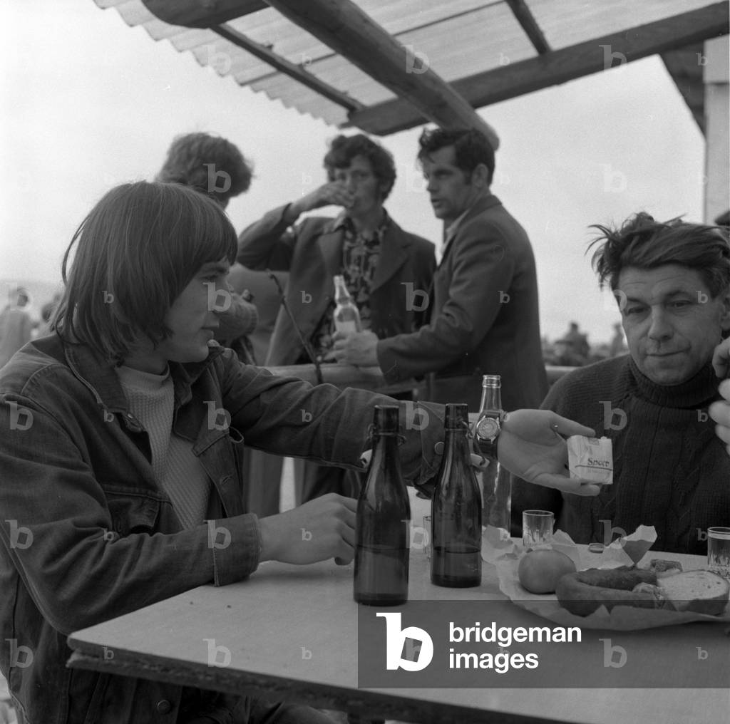 Bodzentyn, Poland, 1973. Farmers sitting in a bar at the local market place. 