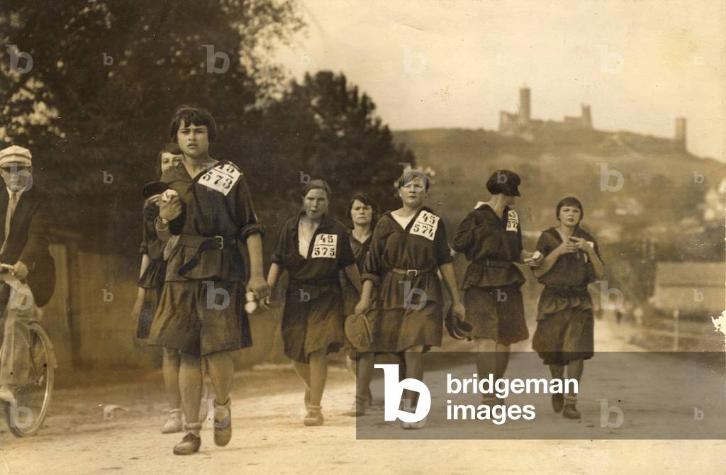 Checiny, inter-war Poland, 1930. School sport competition. Girl representing team from Lviv approaching to the finish (sepia photo)
