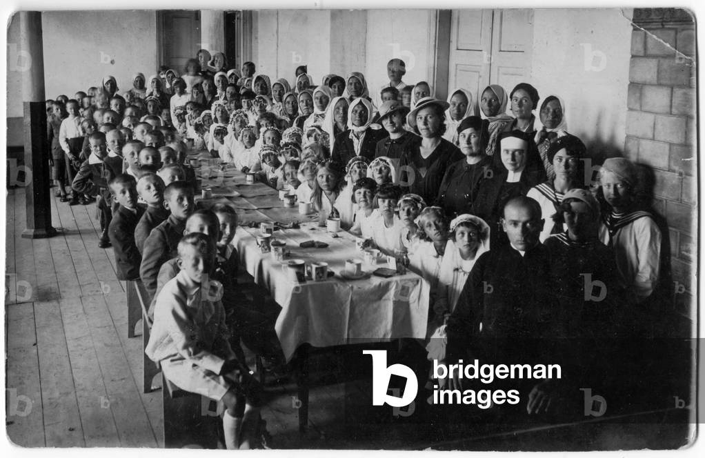 Wizajny, Inter-war period Poland, around 1932. Group picture of children with their mothers during a treat at the presbytery to celebrate the first Holy Communion. Picture from Jadwiga Walecka's family album. Information about picture given by Jadwiga Walecka. 