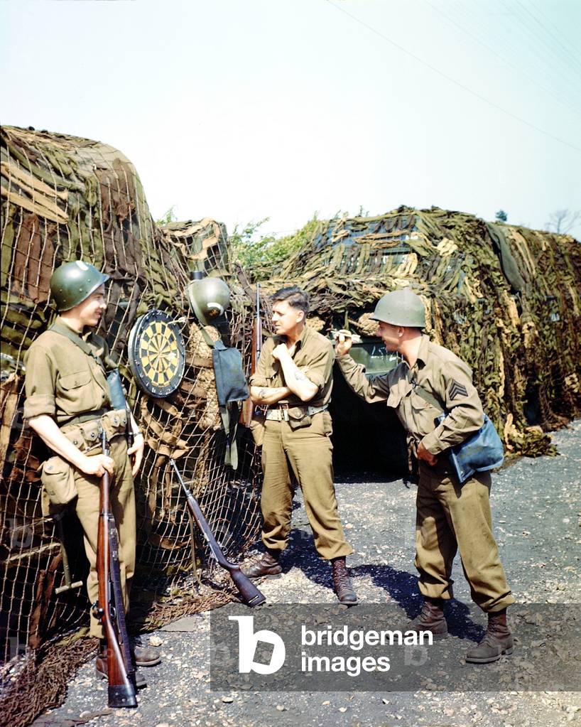 Three American GIs playing darts in a camp near their port of embarkation in the south of England, June 1944 (photo)