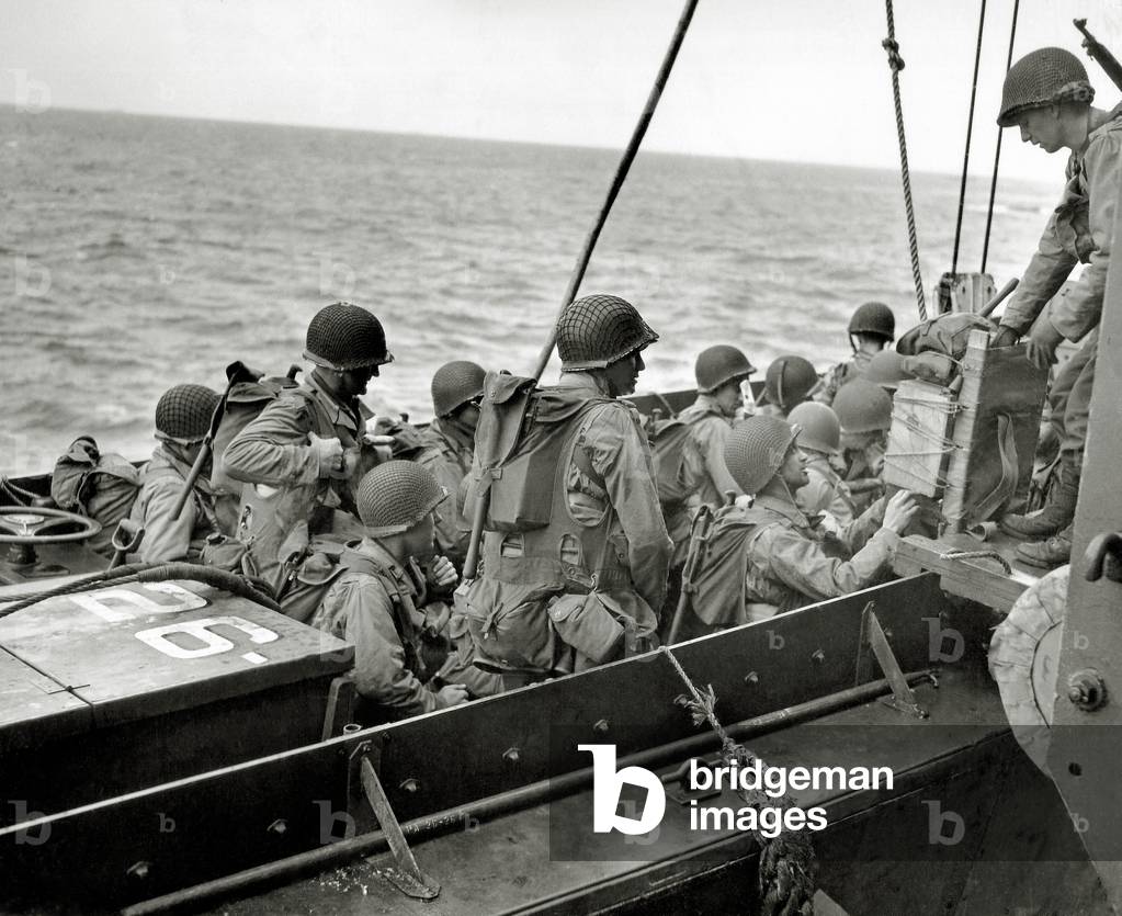 An assault unit completes boarding a Landing Craft, Vehicle, Personnel (LCVP) or the APA 26 USS Samuel Chase, near Omaha Beach, Normandy, France, 6th June 1944 (b/w photo)