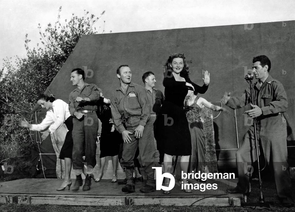 Four French actresses dancing with American soldiers on stage, La Cambe, Normandy, France, 1944 (b/w photo)