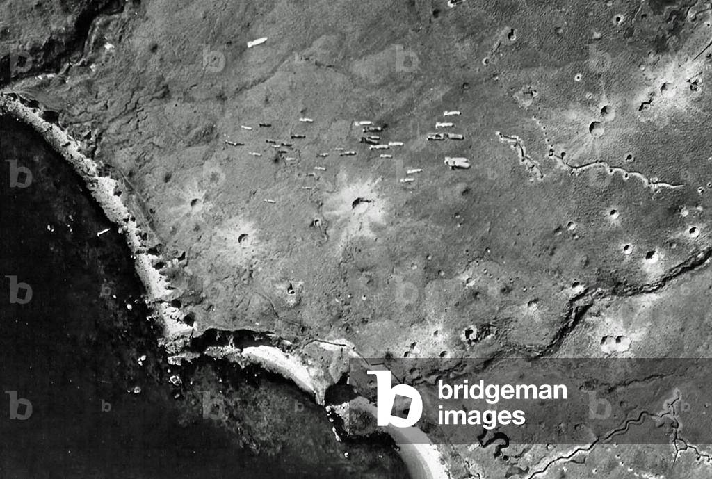 Dozens of bombs fall from a U.S. bomber toward Japanese-occupied Kiska Island, Aleutian Islands, Alaska, USA, 10th August 1943 (b/w photo)