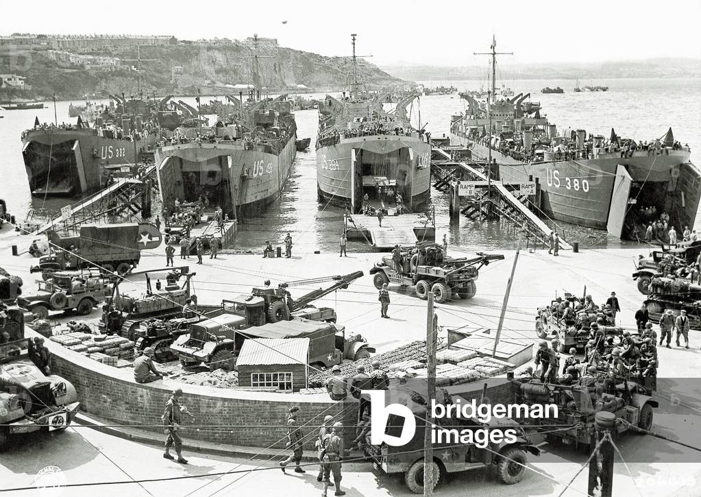 Trucks, jeeps and heavy equipment are loaded on four Landing Ships, Tank (LST 284, 380, 382 and 490), Brixham Harbour, Devon, United Kingdom, 1st June 1944 (b/w photo)