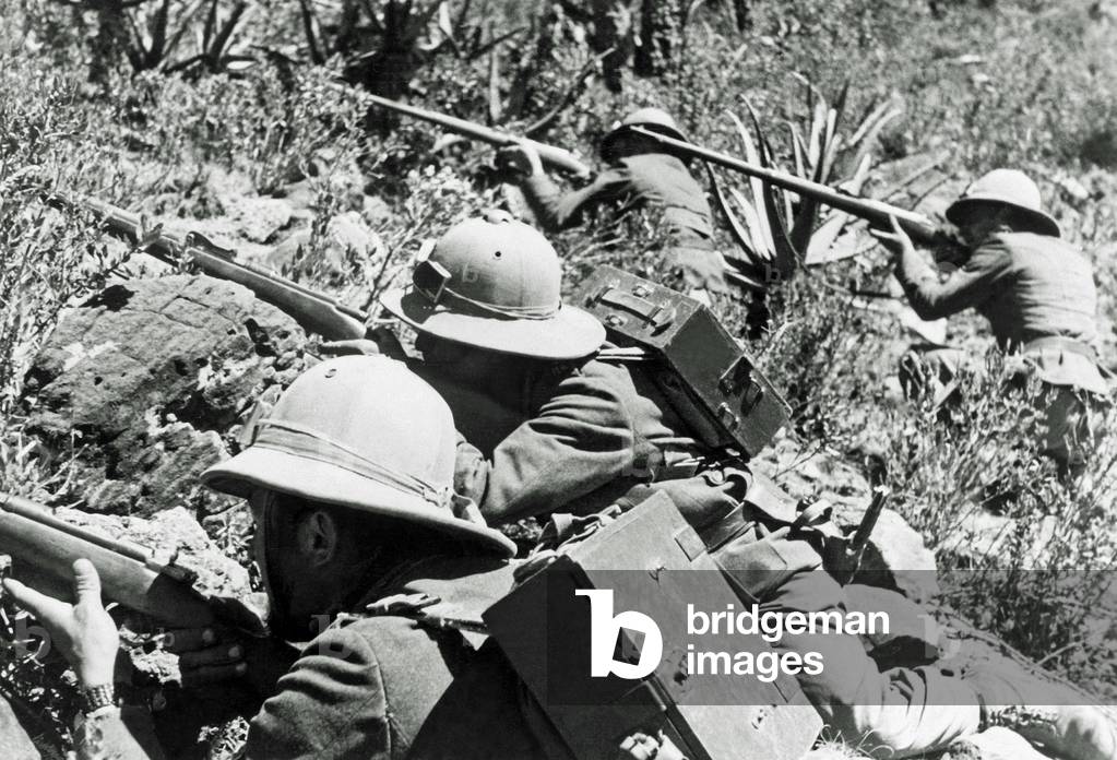 Four Italian soldiers are taking aim in Ethiopia during the Second Italo-Ethiopian War, also referred to as the Italo-Abyssinian War, 1935 (b/w photo)