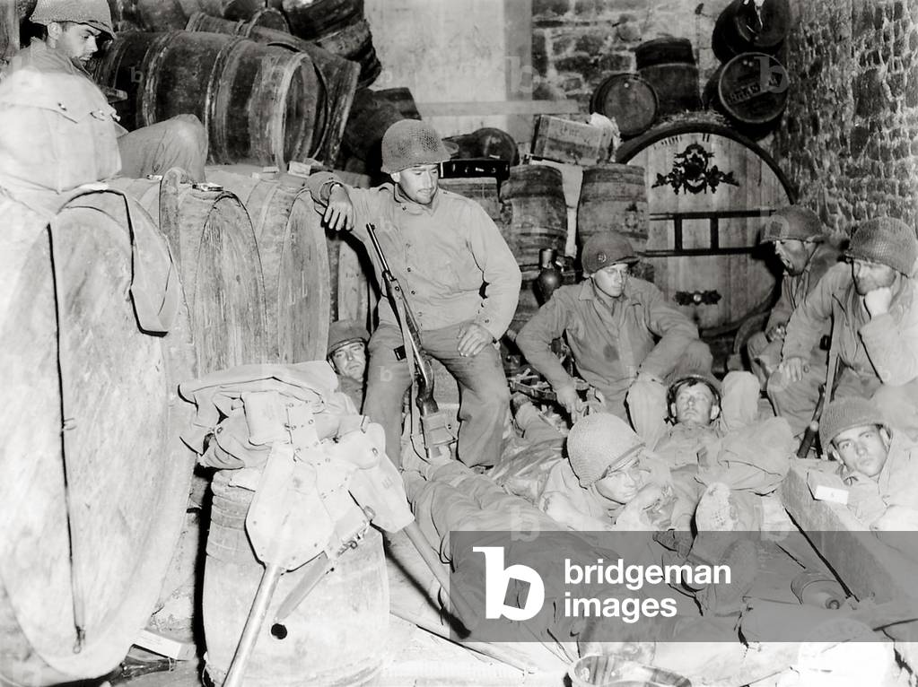 American soldiers in a basement with barrels of cider, Tessy-sur-Vire, Normandy, France, 3rd August 1944 (b/w photo)