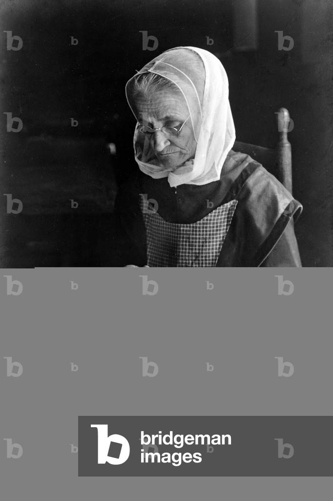 SHAKER WOMAN, 1907 An elderly woman making shaker apple sauce. Photograph by John H. Tarbell, 29 November 1907.