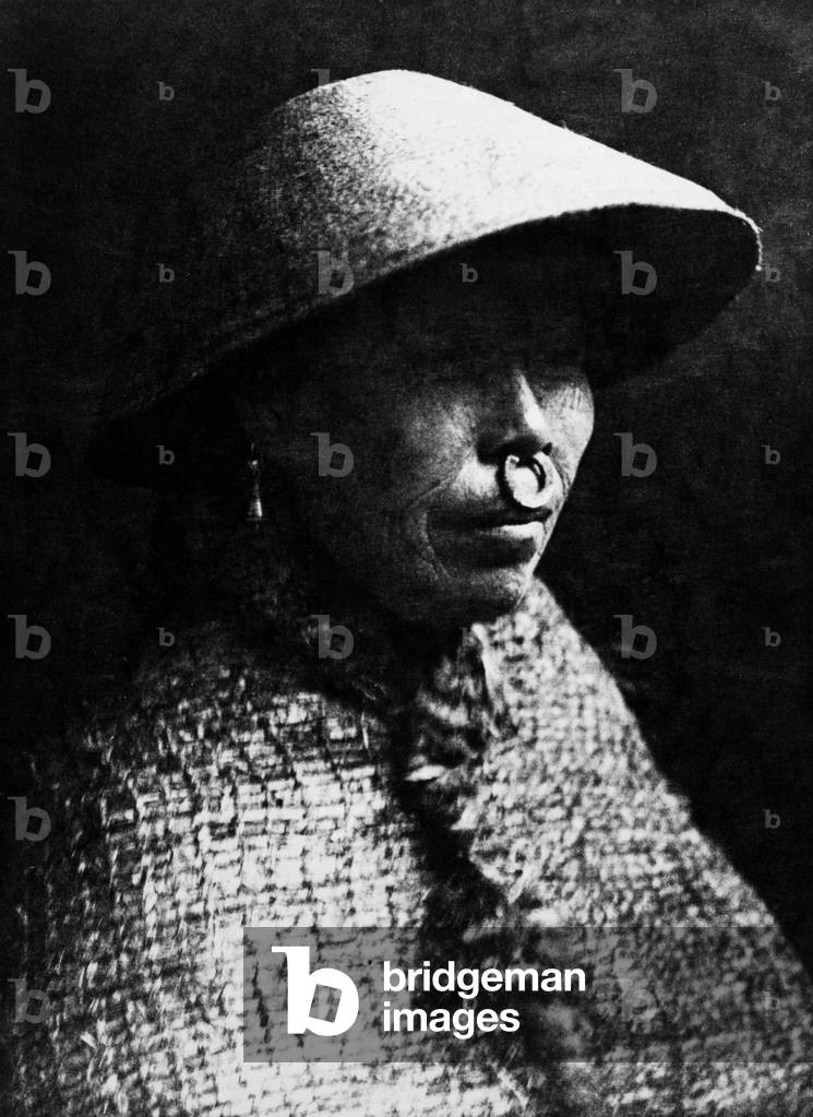 CLAYOQUOT WOMAN, 1915 A Clayoquot woman, from the west coast of Vancouver Island, British Columbia, Canada, wearing a cedar bark hat and cape. Photographed by Edward S. Curtis, 1915.