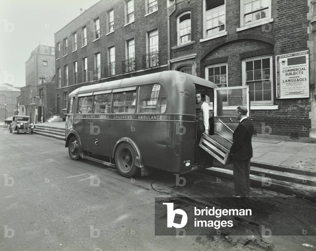 Trinity Street Feeding Centre: two men loading an ambulance, 1937 (b/w photo)