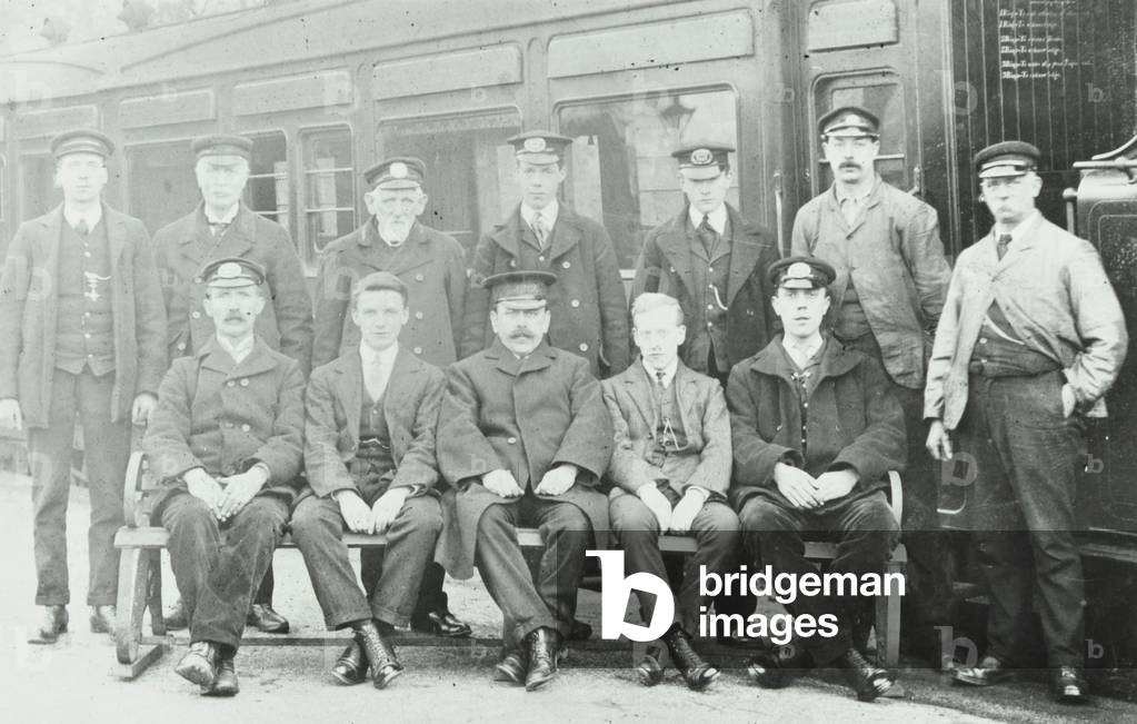 Railway station staff at unknown station, 1900 (b/w photo)