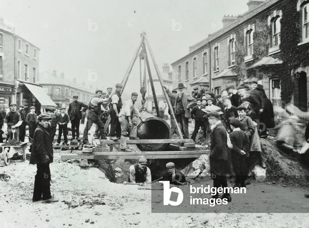 Wandsworth Town Station: removal of a 'Gas Light or Coke Company' gas main, 1906 (b/w photo)