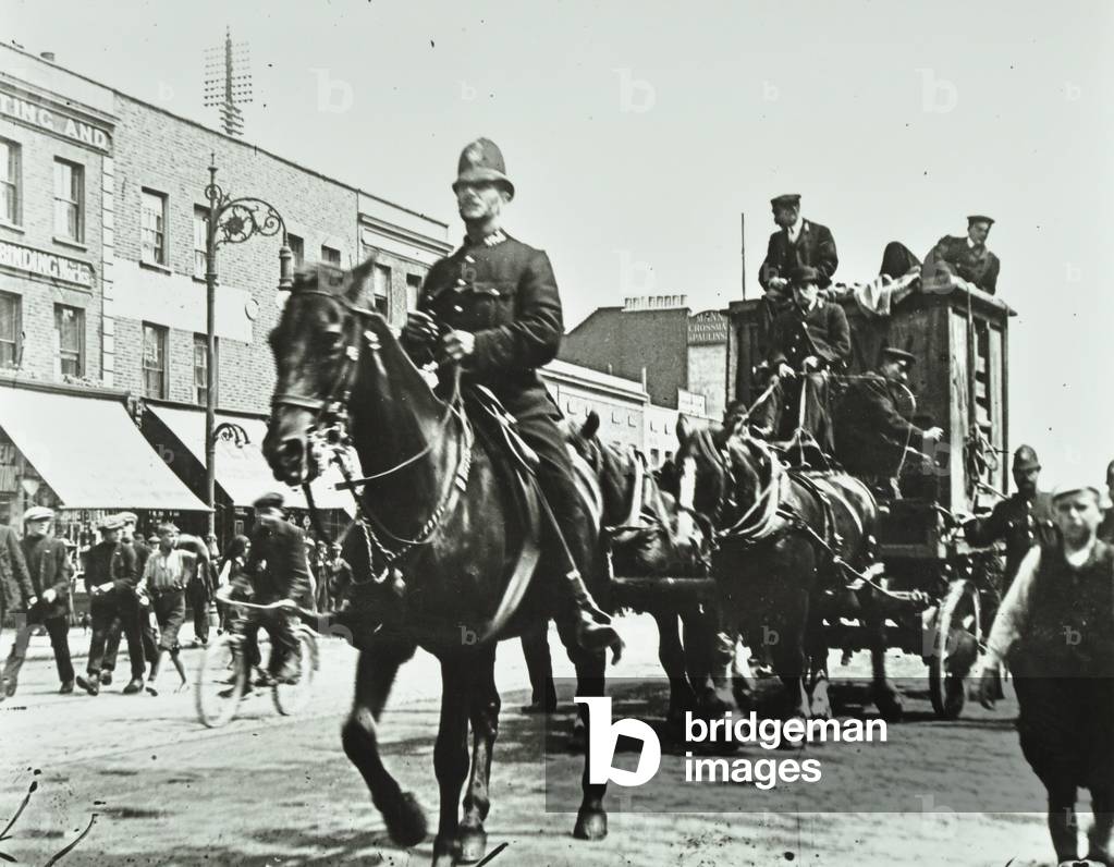 Zoo transport on East India Dock Road, together with a police escort, London, 1920 (b/w photo)