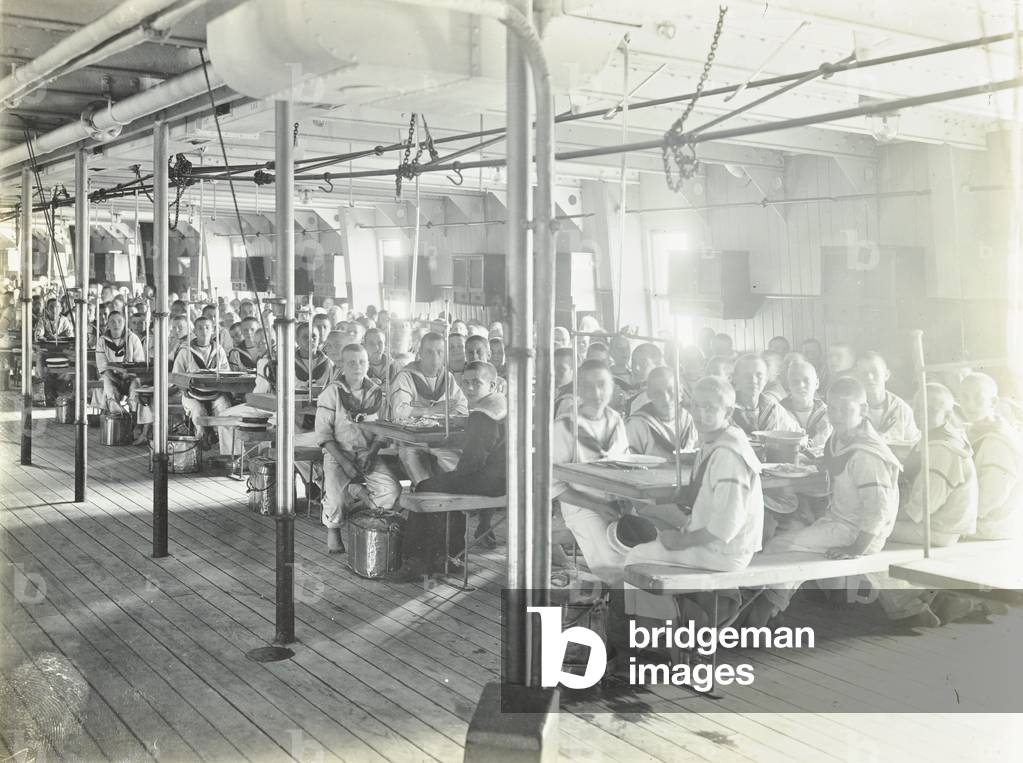 Exmouth Training Ship: mess room, boys seated at rows of tables, 1910 (b/w photo)